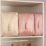 Space-saving, self-compressing storage bag