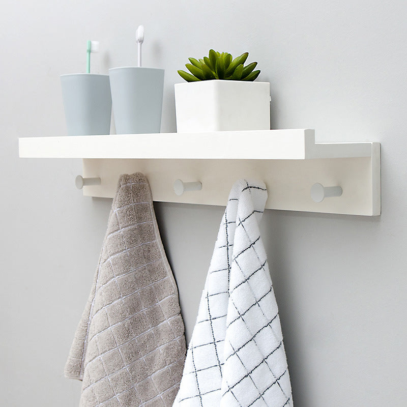 Elegant Wall Shelf with Hooks for Optimal Storage Space