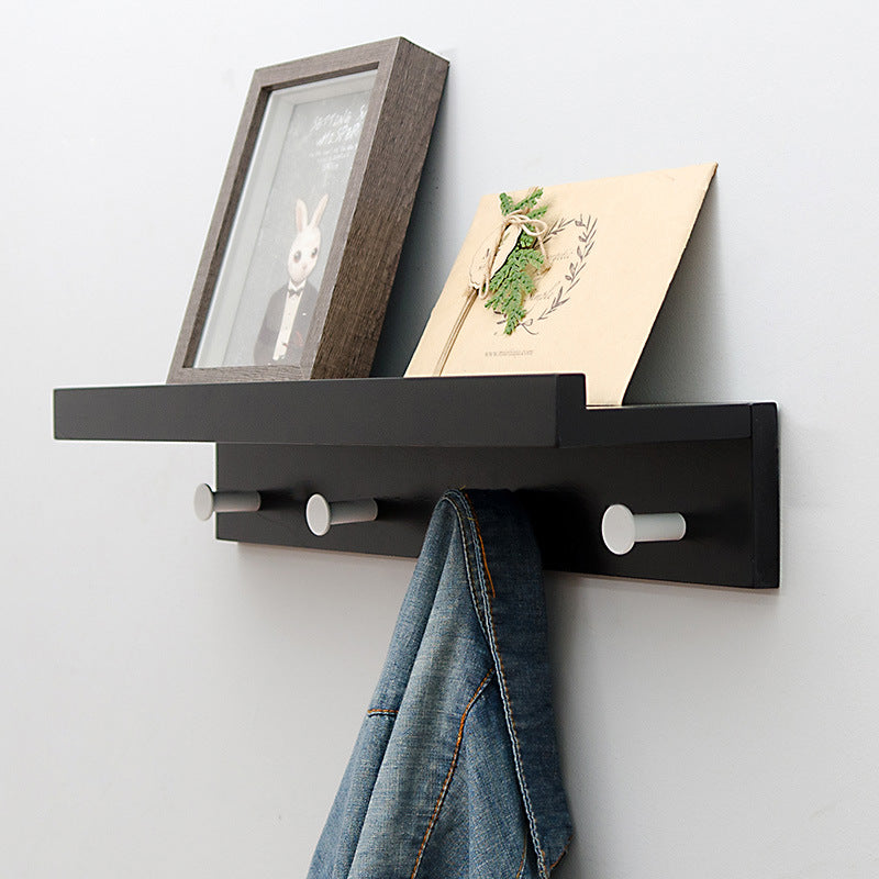 Elegant Wall Shelf with Hooks for Optimal Storage Space