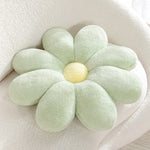 Pastellfarbiges Kissen mit flauschigem Gänseblümchenmuster
