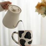 Lustige Milchkanne: Kaffeetasse mit Kuhdesign