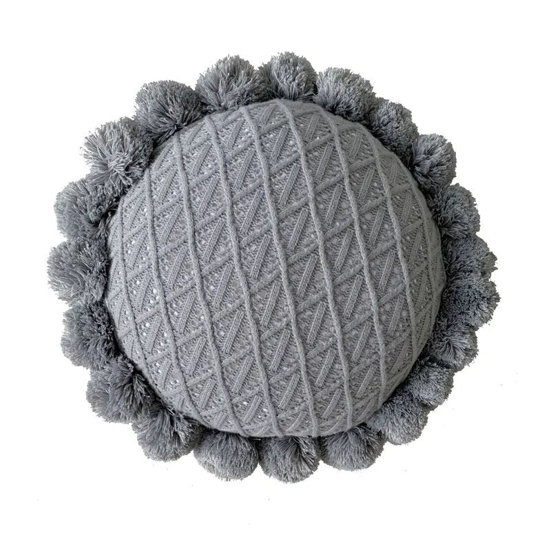 Runder Kuschelkissen mit Pompom und Quaste aus Acrylstrick